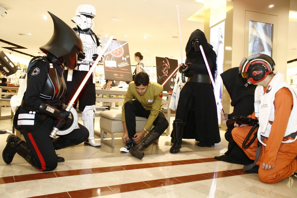 Sanjiv Indran from Star Wars Malaysia Fan Club (SWMFC) trying on the Darth Vader Bata Tennis shoes.